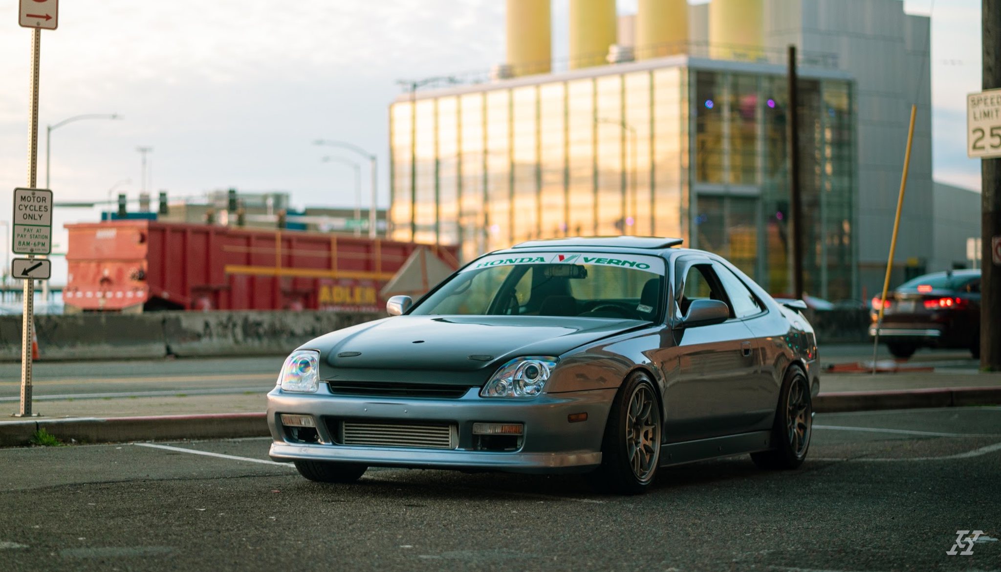 Crystal Blue Metallic Honda Prelude parked at golden hour in front of a glass building, after an exterior detail by High Standard Auto Salon